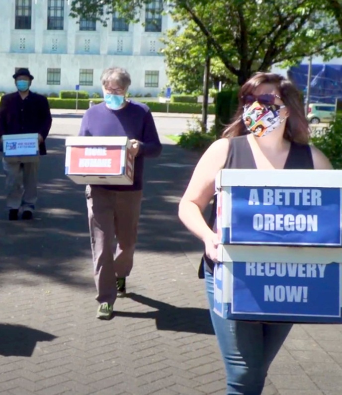 People carry boxes of signatures for Oregon's Measure 110 to decriminalize all drugs in Oregon.