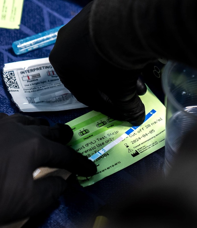A person checks a fentanyl test strip.
