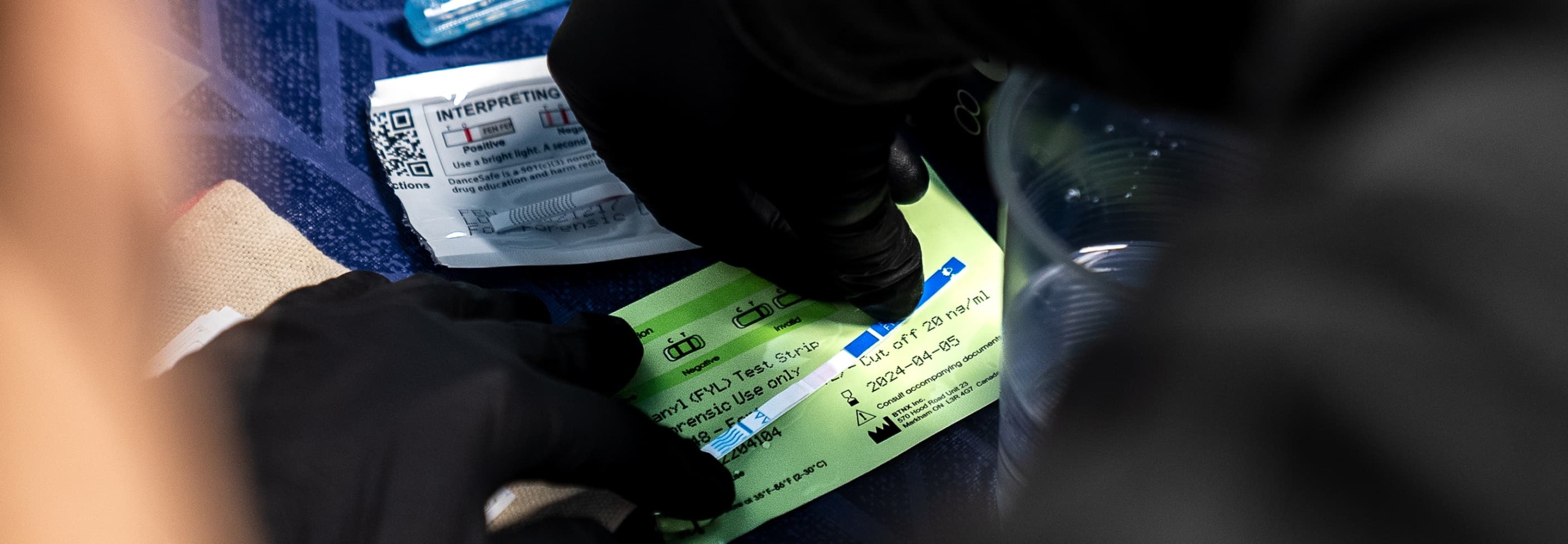 A person checks a fentanyl test strip.
