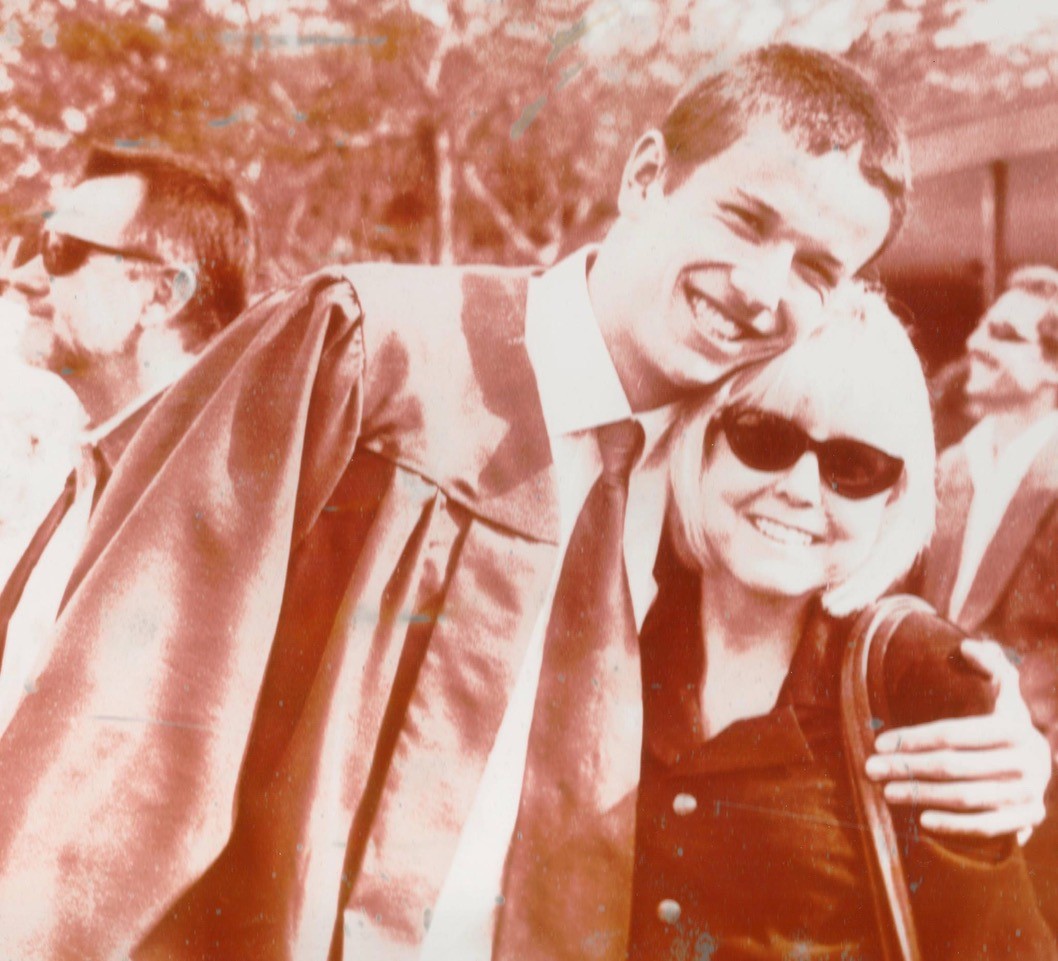 Imagine of a man and his mom on his graduation day.