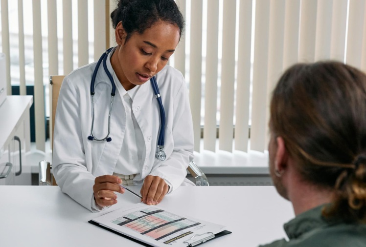 Photo of a doctor sitting with a patient